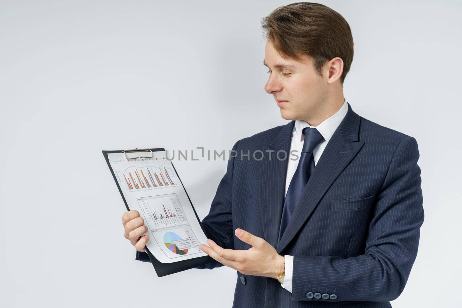 Businessman holds in his hands a tablet with reports. White background. Business and finance concept