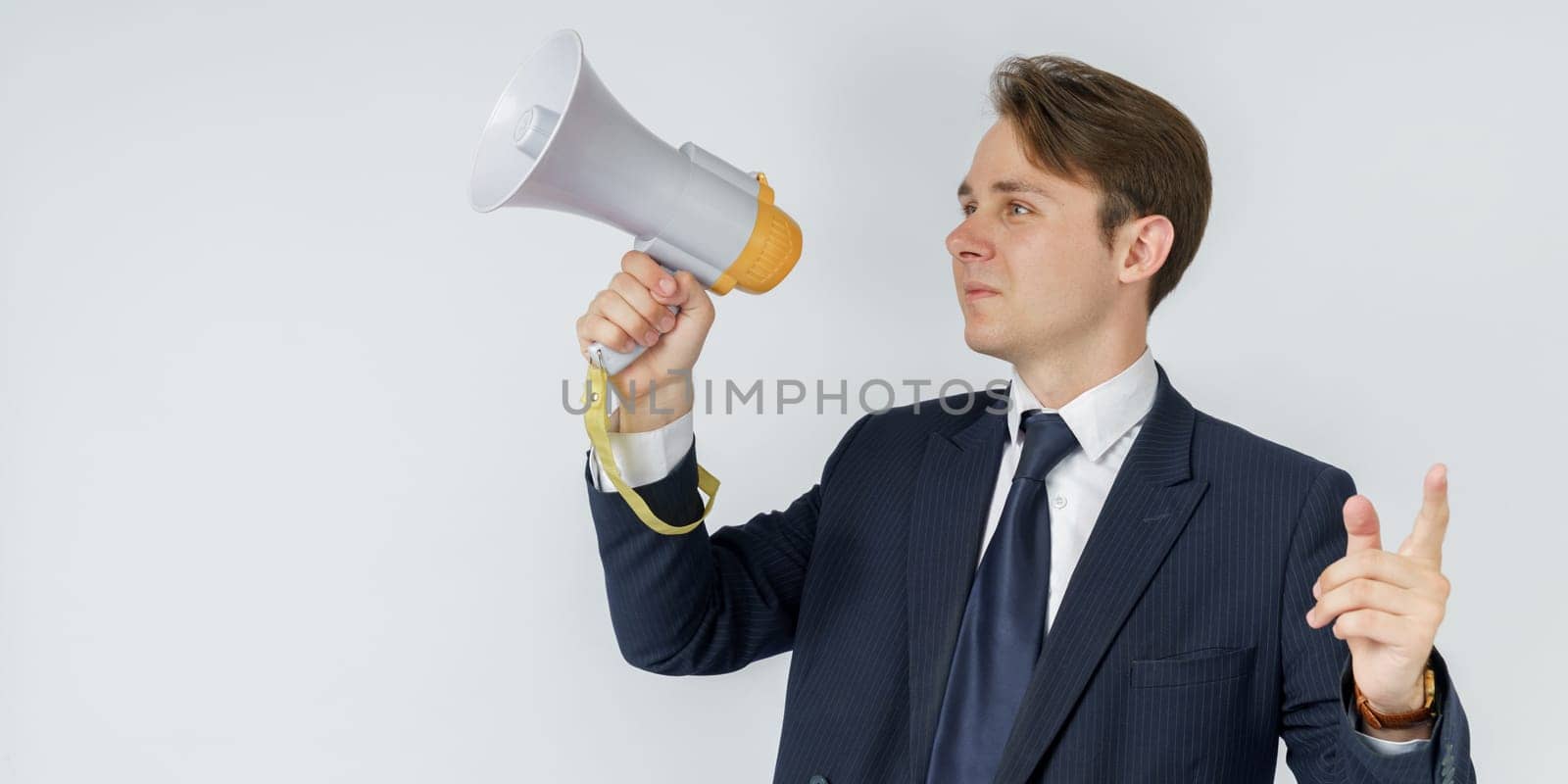 Portrait of a businessman who holds a jacket on his shoulder. The face is not visible. White background.