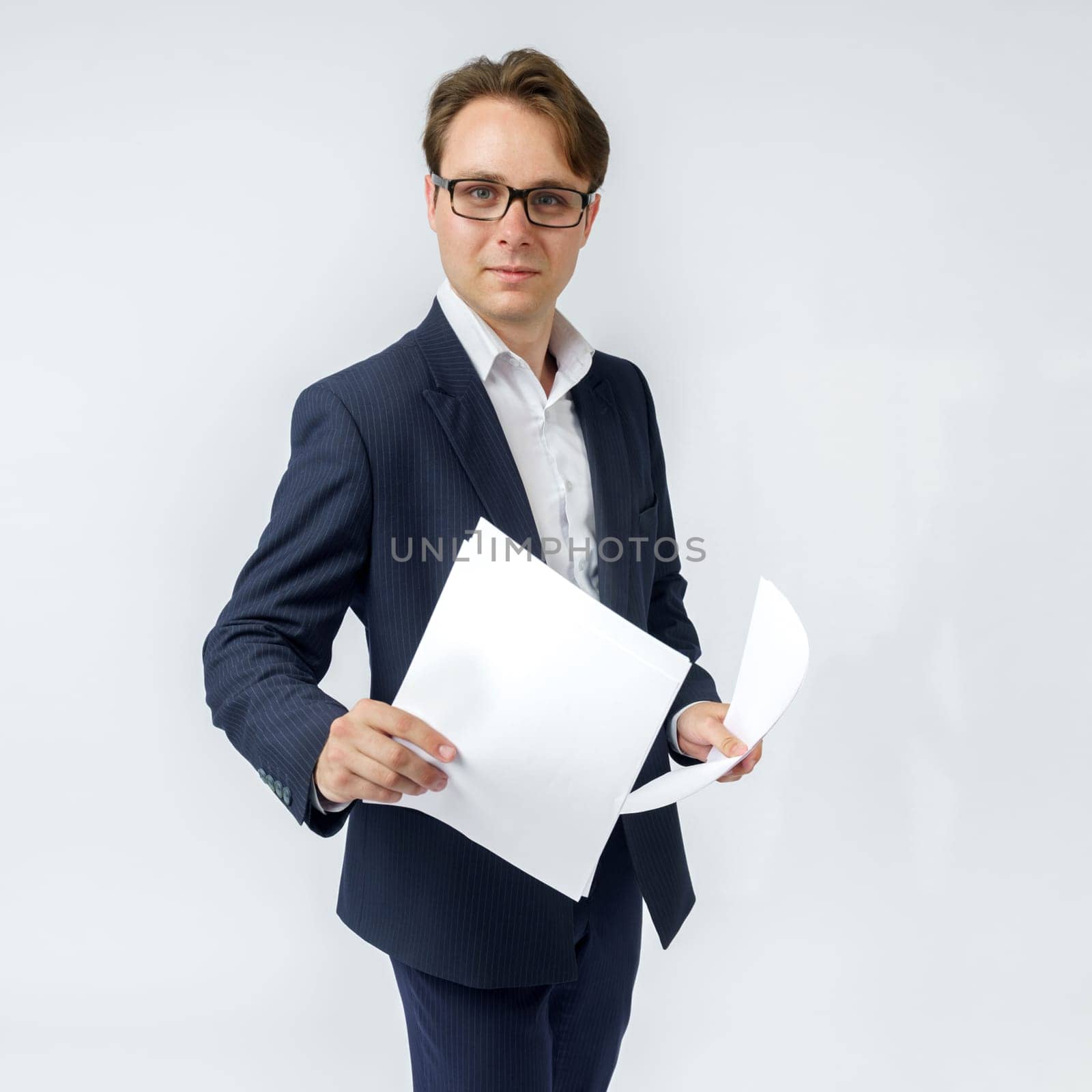 Businessman with scattered papers. Business, people, emotions - businessman throws documents in the office. Business and finance concept.