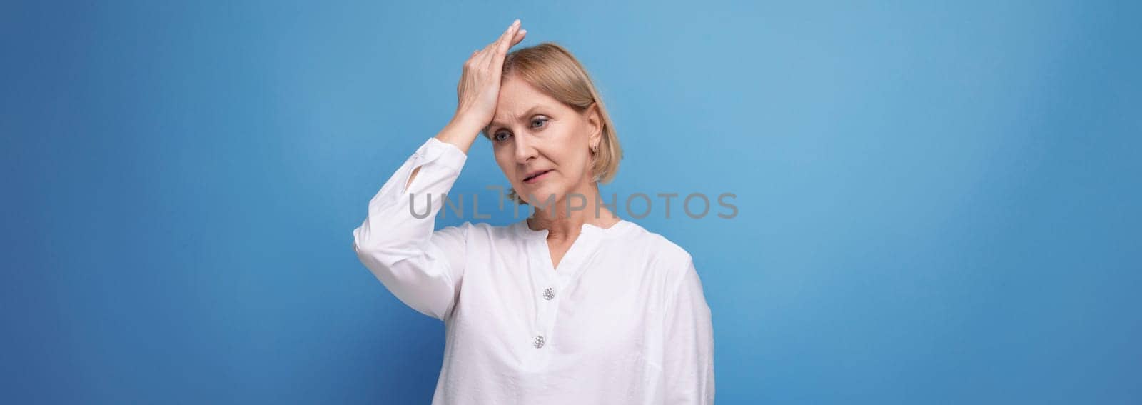 blond middle aged woman with headache and premenstrual syndrome by TRMK