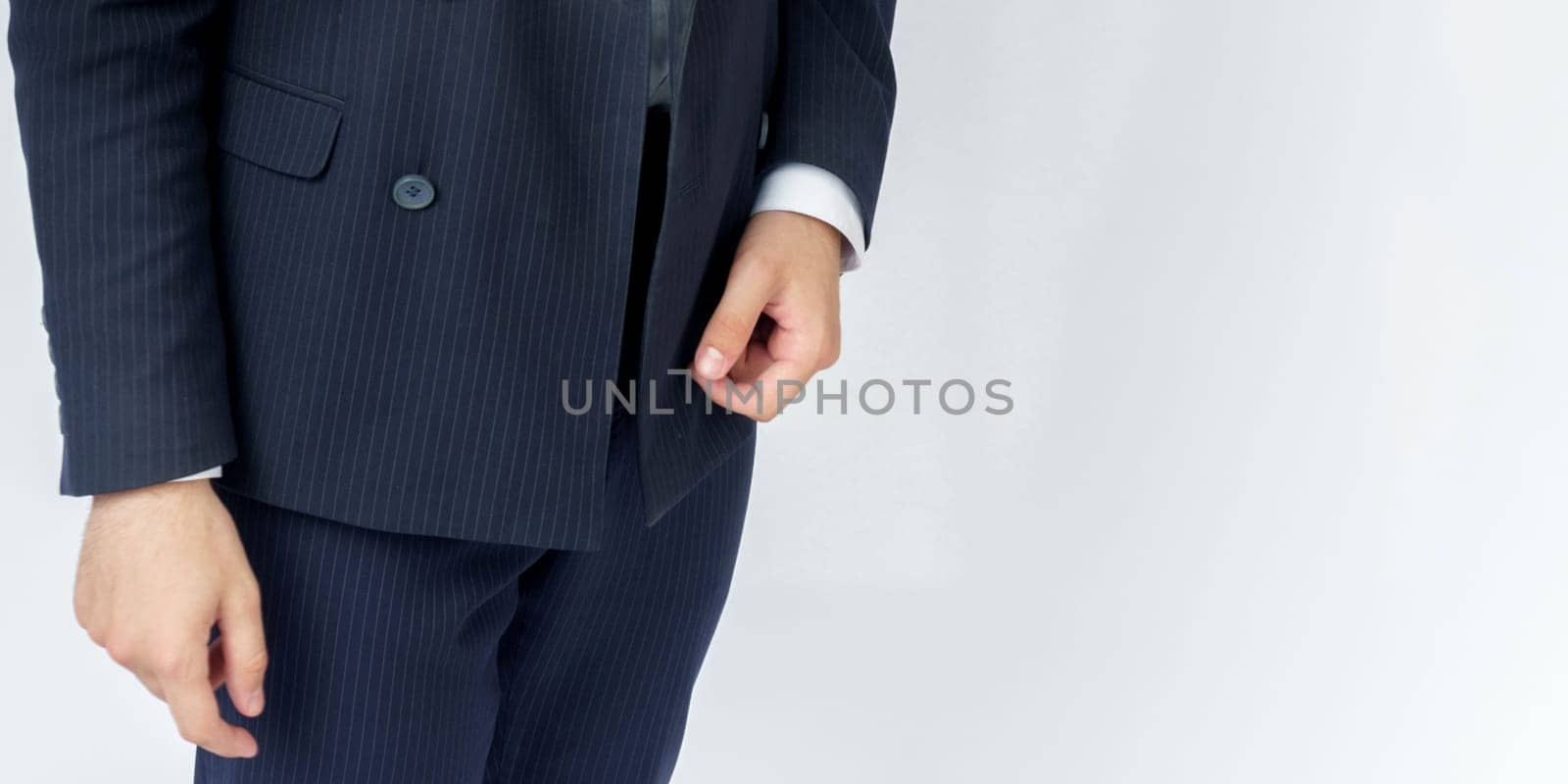 Portrait of a businessman, only hands are visible. The face is not visible. White background. Business and finance concept