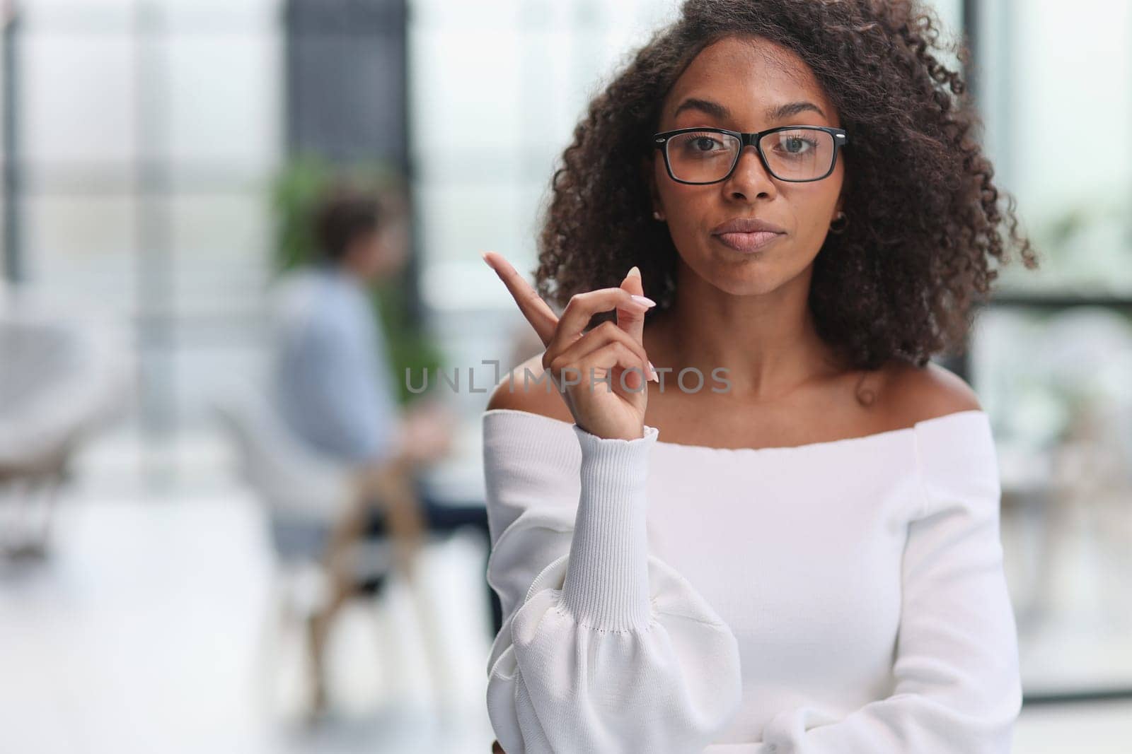 Portrait of business woman showing finger gesture to the side