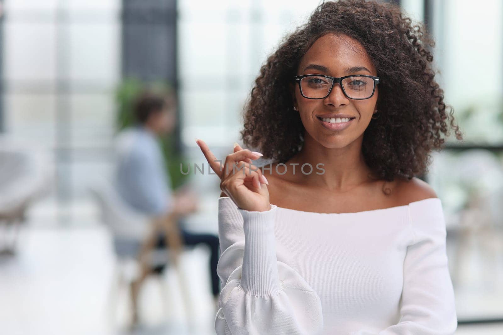 Portrait of business woman showing finger gesture to the side
