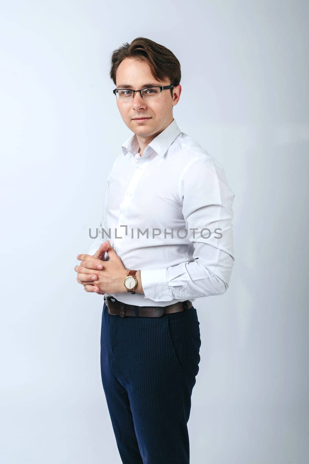 Business and finance concept. A man in a white shirt with glasses. Light background