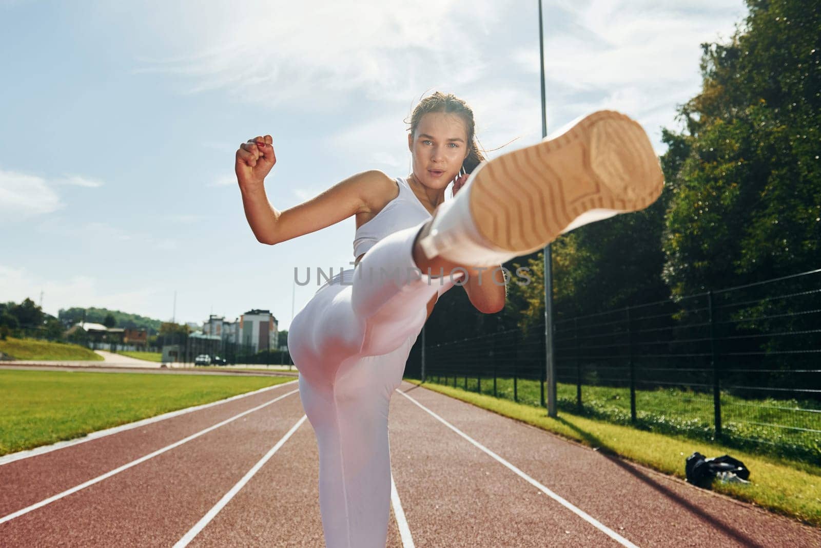 Self defence conception. Young woman in sportive clothes is exercising outdoors.