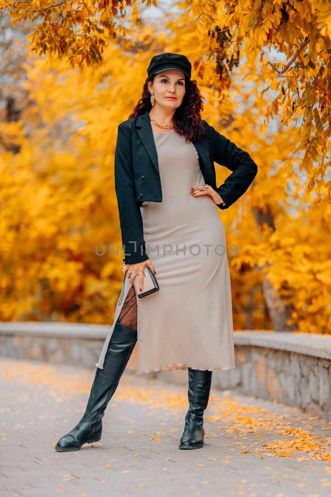 A woman walks outdoors in autumn, enjoys the autumn weather