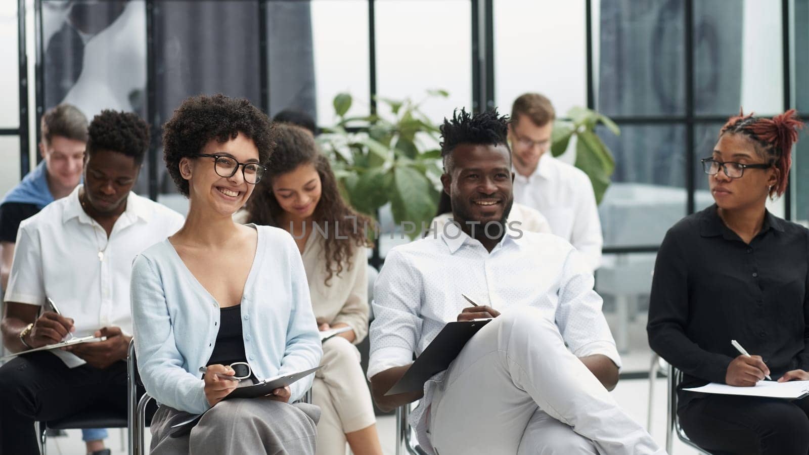 a group of people at a lecture listening attentively to the speaker
