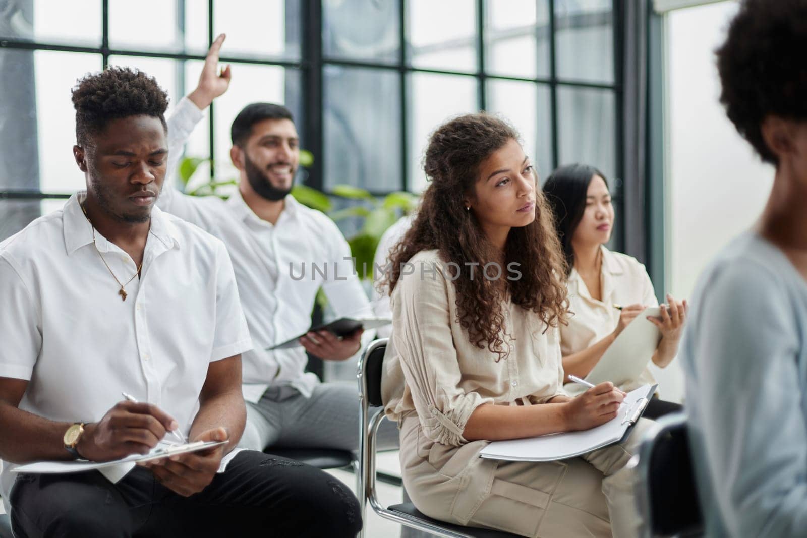 Daily meeting. A group of young people are discussing something while sitting at a table in the conference hall