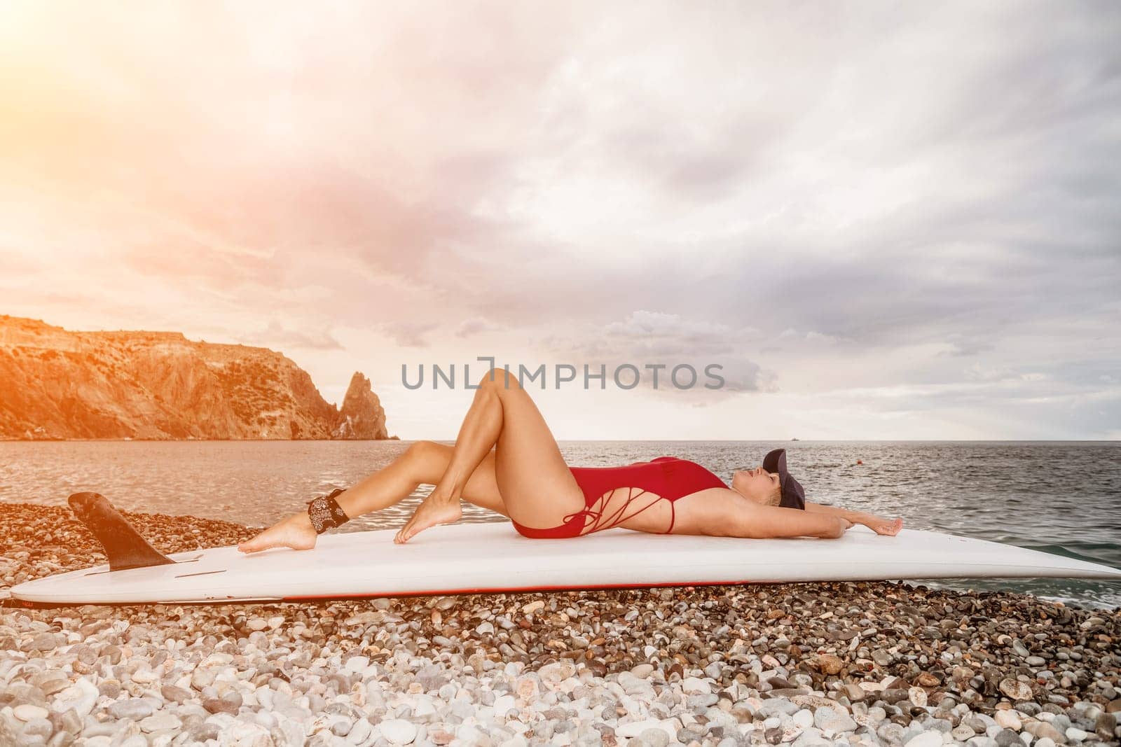 young woman in stylish bikini lying on seashore, closeup. Holiday, vacation and recreational concept.