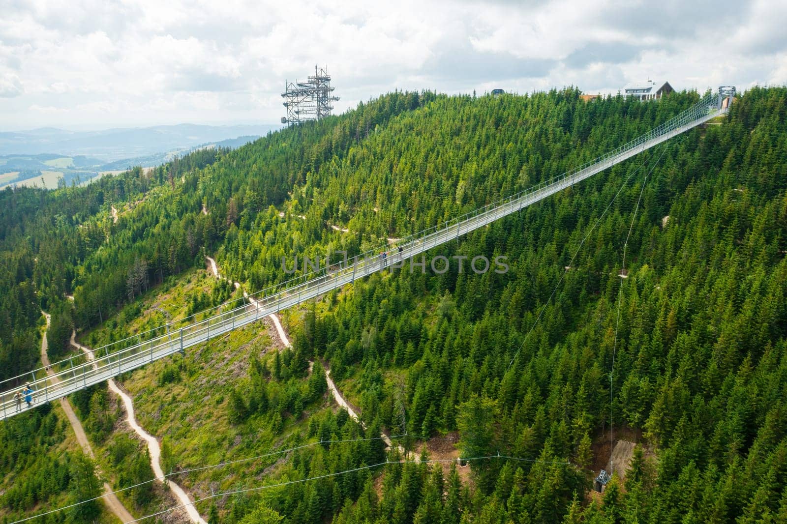 Aerial view of the worlds longest 721 meter suspension footbridge Sky bridge and observation tower the Sky walk in the forest, between mountains, Dolni Morava Ski Resort, Czech Republic.
