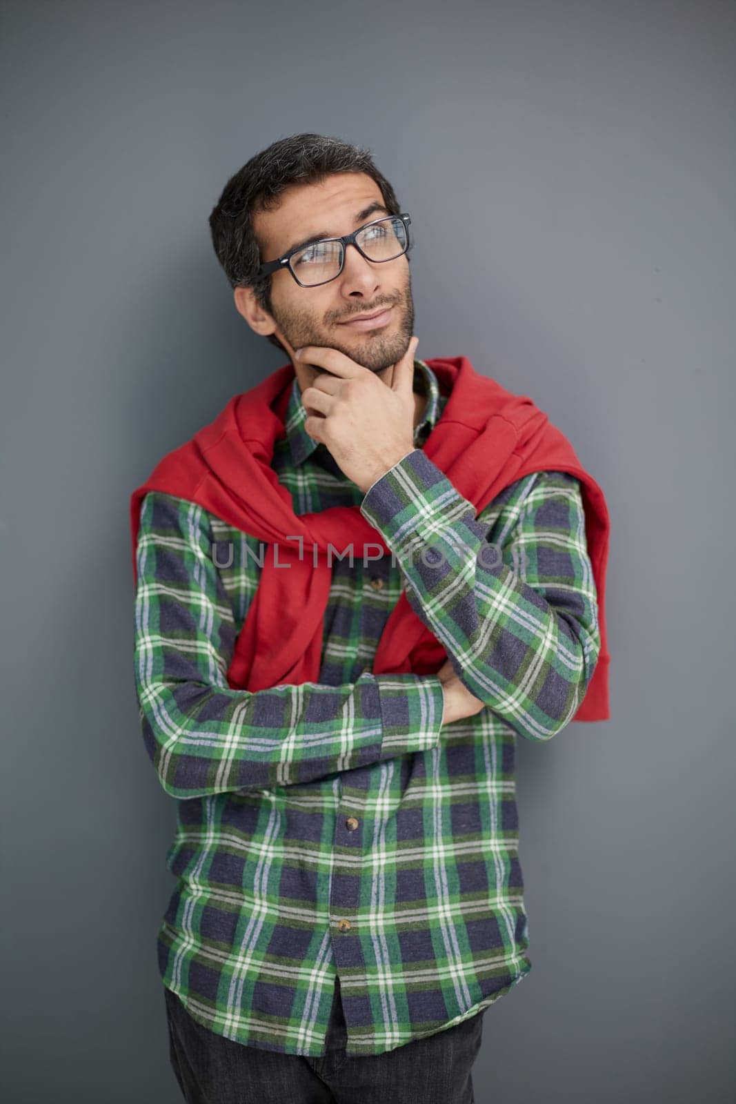 Handsome man in plaid shirt isolated on gray background