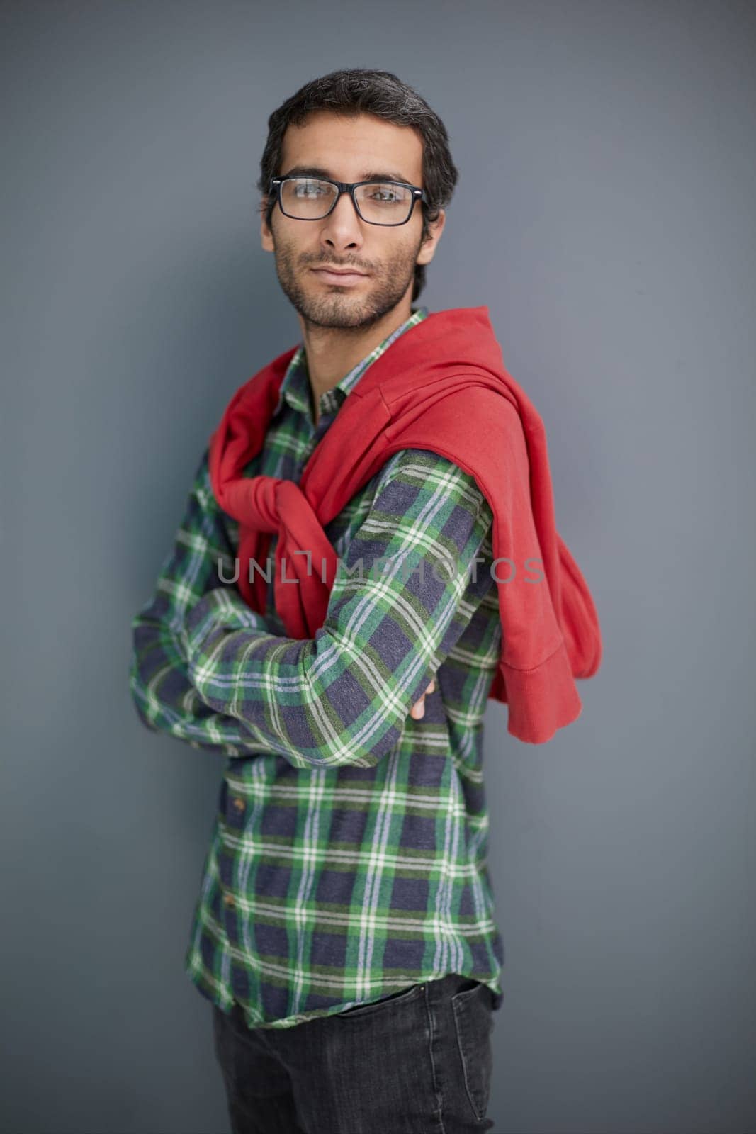 Stylish young man posing in the studio on gray background