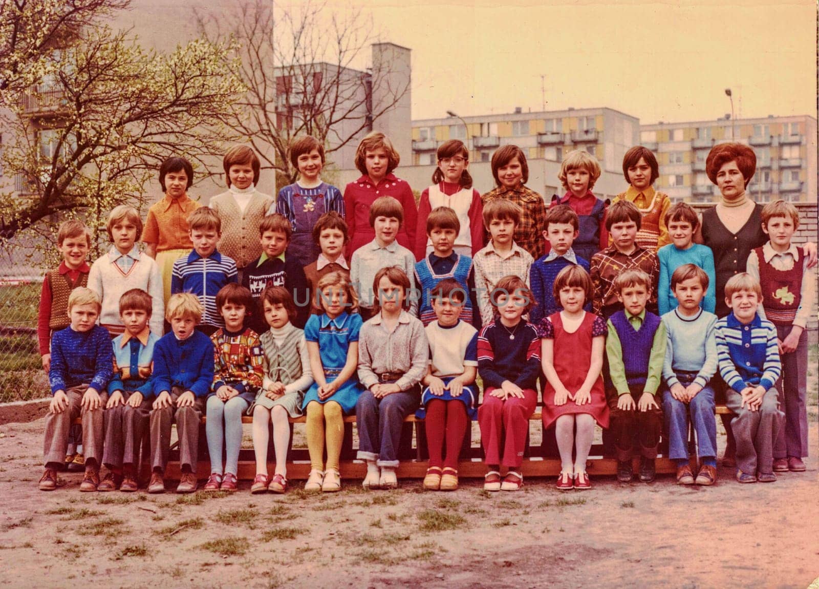 Retro photo shows pupils schoolmates and their female teacher. by roman_nerud