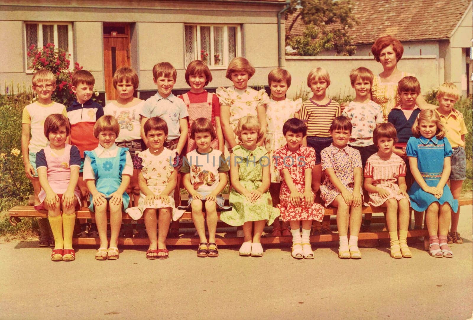 Retro photo shows pupils outdoors. They pose for a group photography by roman_nerud