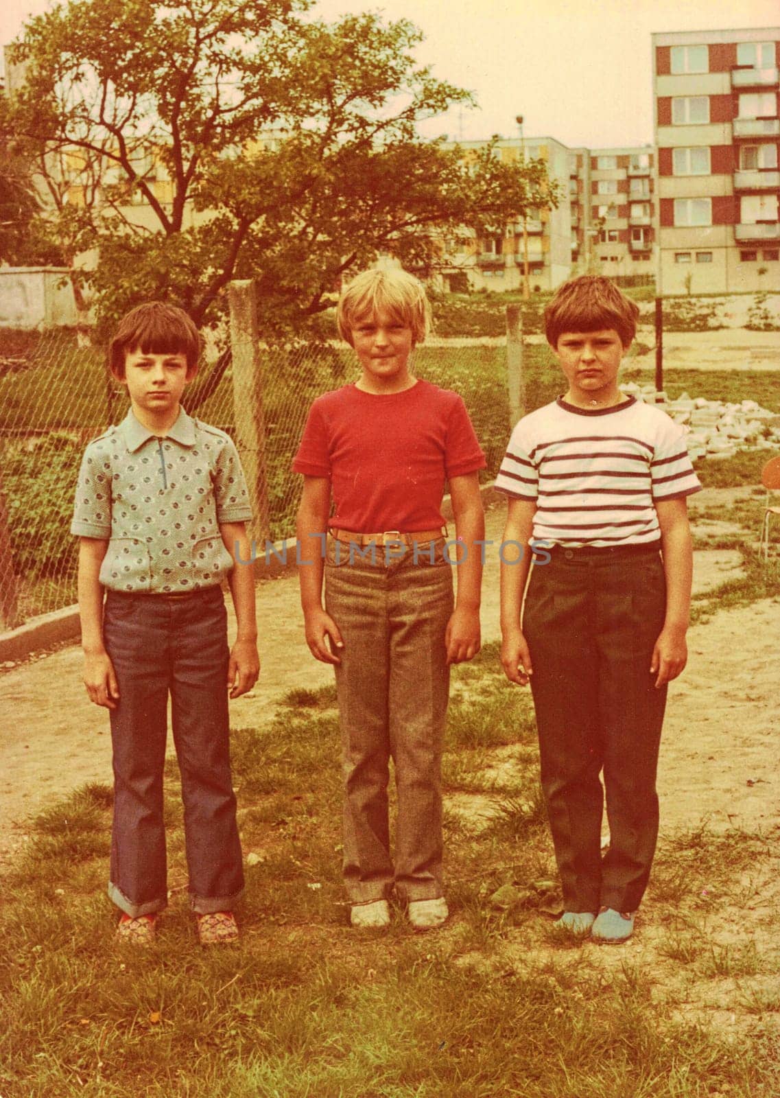 Retro photo shows pupils boys outdoors. They pose for a group photography. Color photo. by roman_nerud