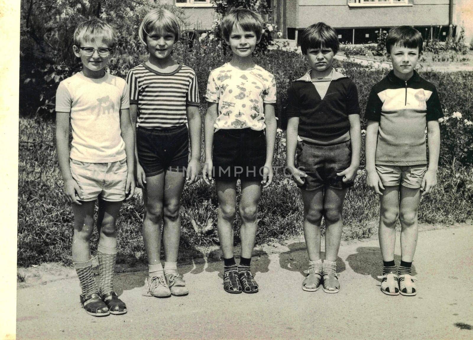 Retro photo shows pupils boys outdoors. They pose for a group photography. Black white photo. by roman_nerud