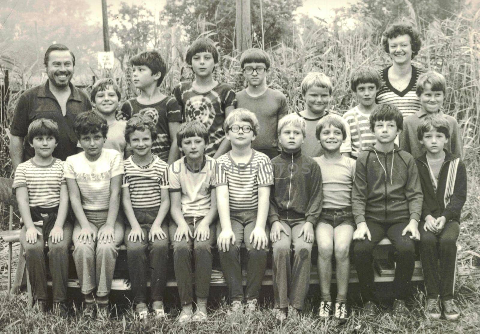 Retro photo of group of school pupils teenagers with their teachers at summer camp. Black white photo by roman_nerud