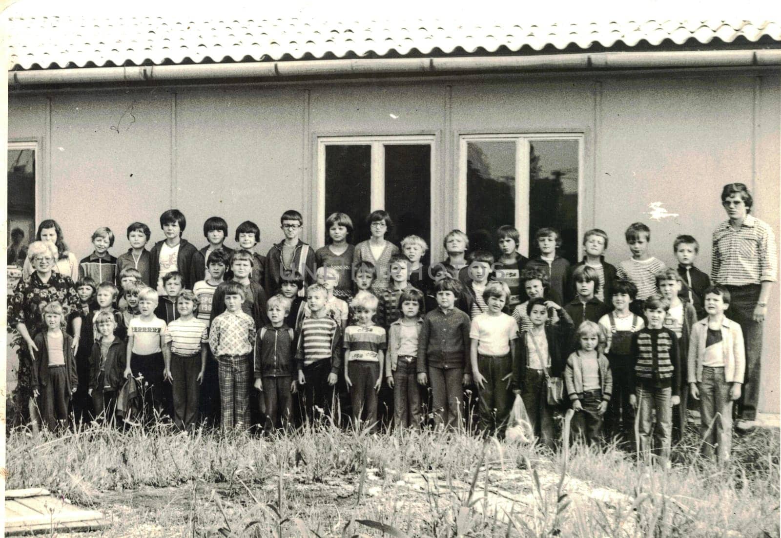 Retro photo of group of school pupils young pioneers with their teachers at summer camp. Black white photo by roman_nerud