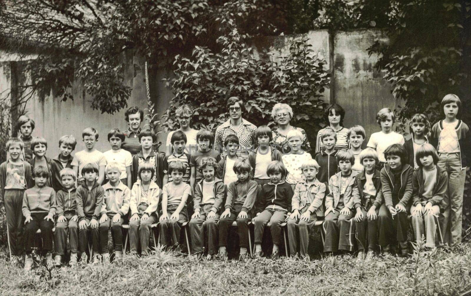 Retro photo of group of school pupils young pioneers with their teachers at summer camp. Black white photo by roman_nerud