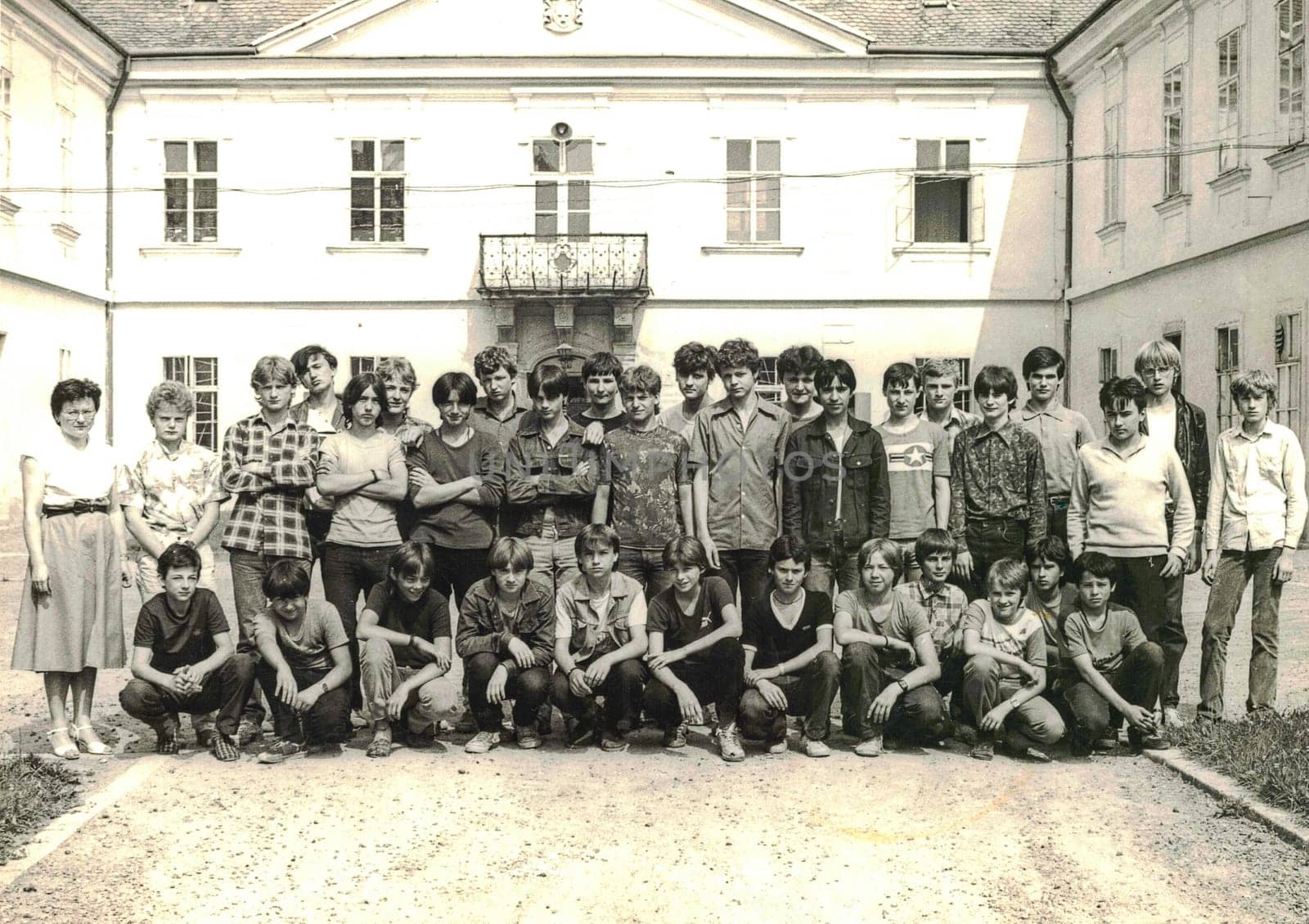 Retro photo of group of school students boys with their female teacher. Students of technical school. Black white photo by roman_nerud