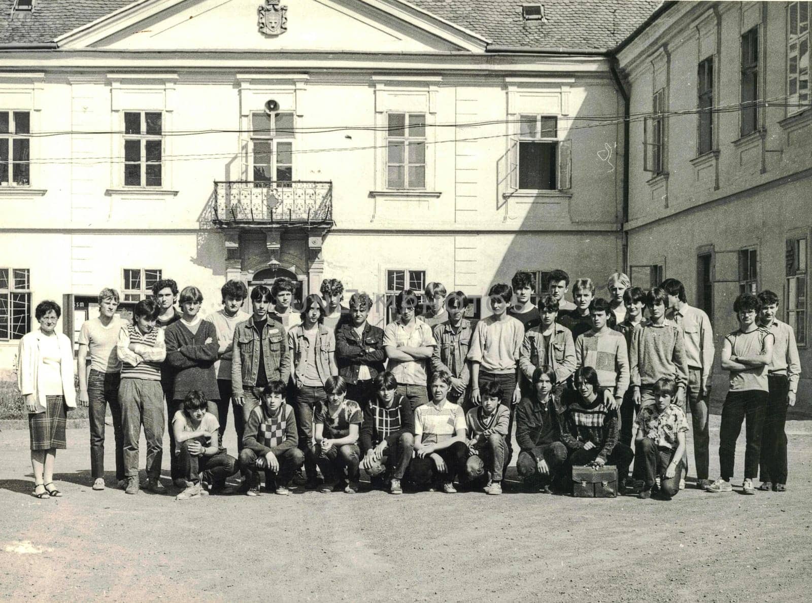 THE CZECHOSLOVAK SOCIALIST REPUBLIC - CIRCA 1980s: Retro photo shows group of school students (boys) with their female teacher. Students of technical school. Black white photo