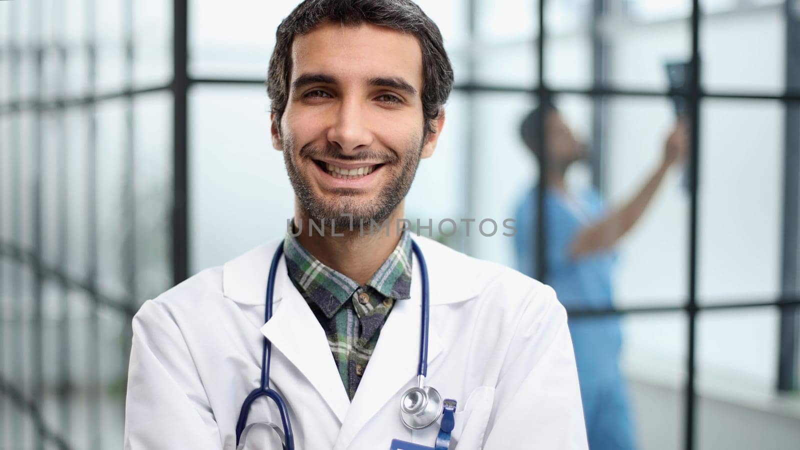 Portrait of young doctor standing in hospital hall