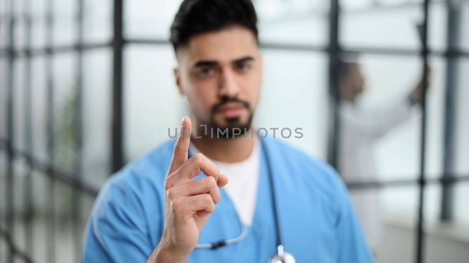 A portrait male doctor pointing at a copy space