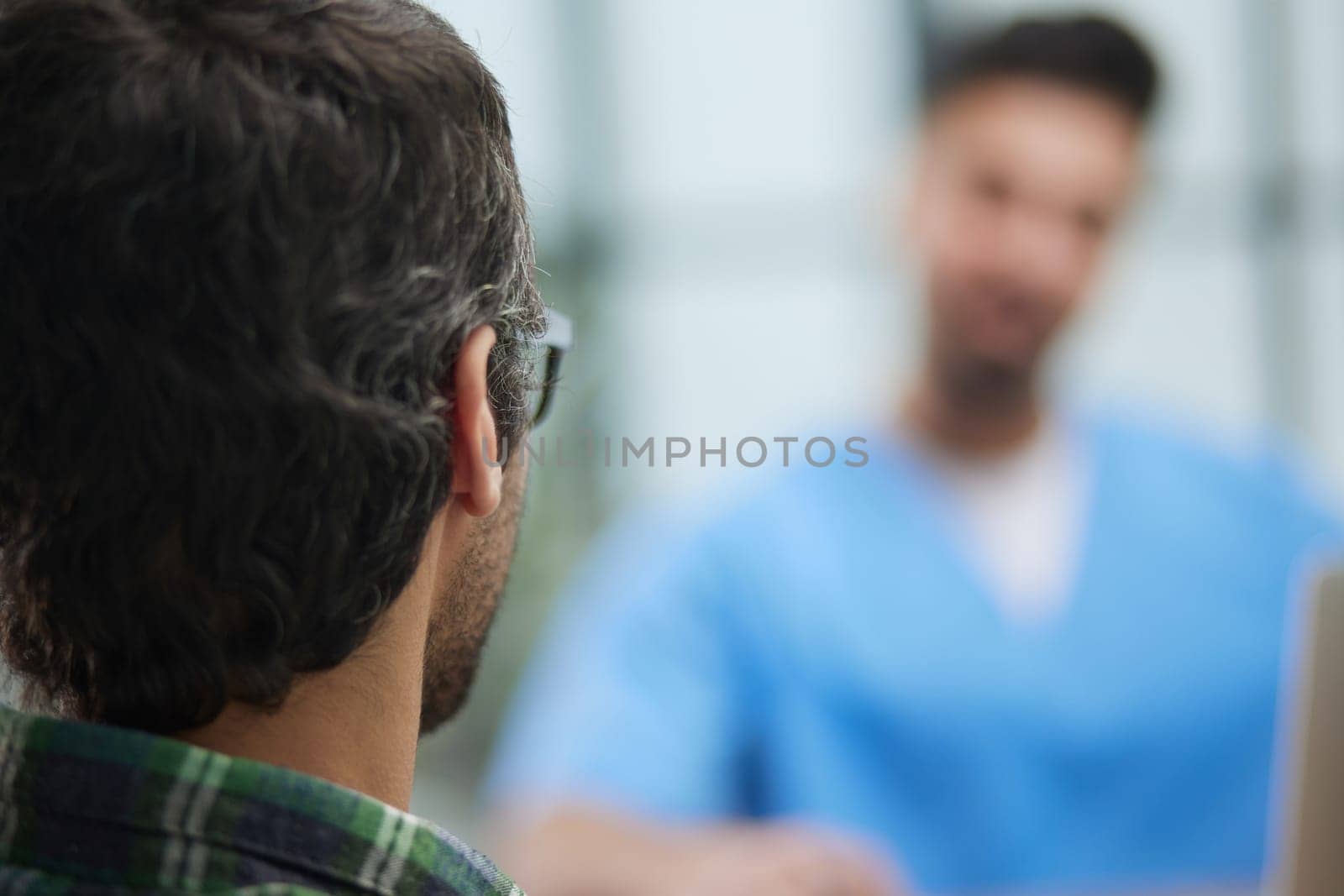 Nurse explaining to a young male patient in an office in a hospital