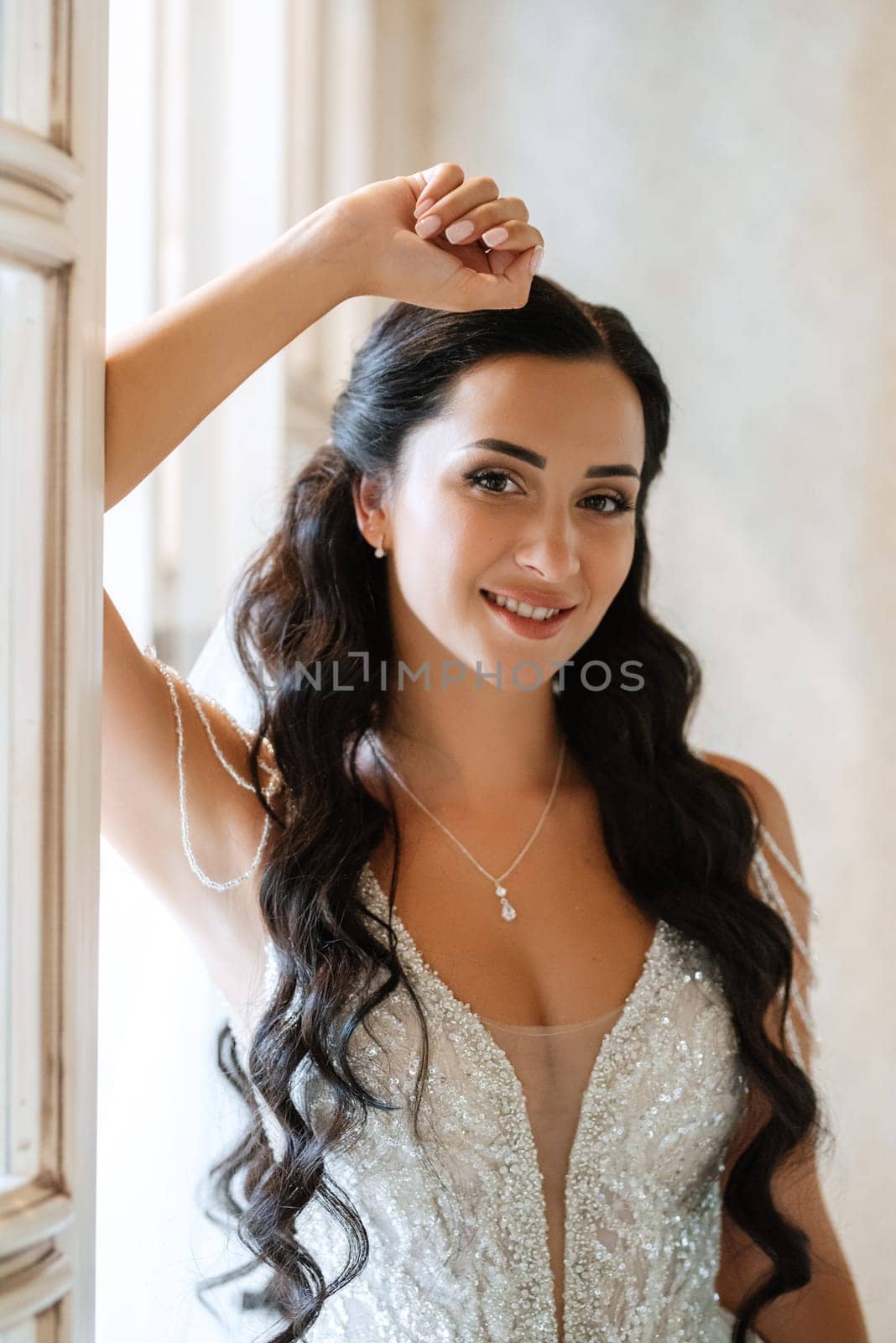 portrait of a bride in a white dress in a bright cafe with mirrors