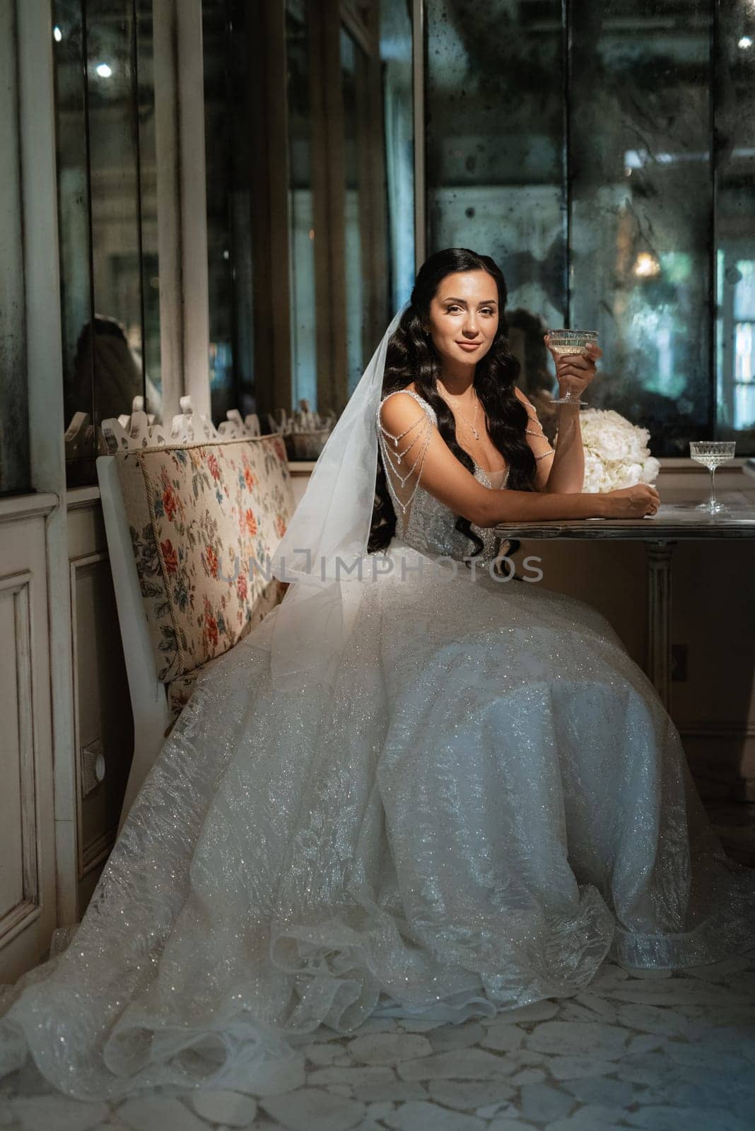 portrait of a bride in a white dress in a bright cafe by Andreua