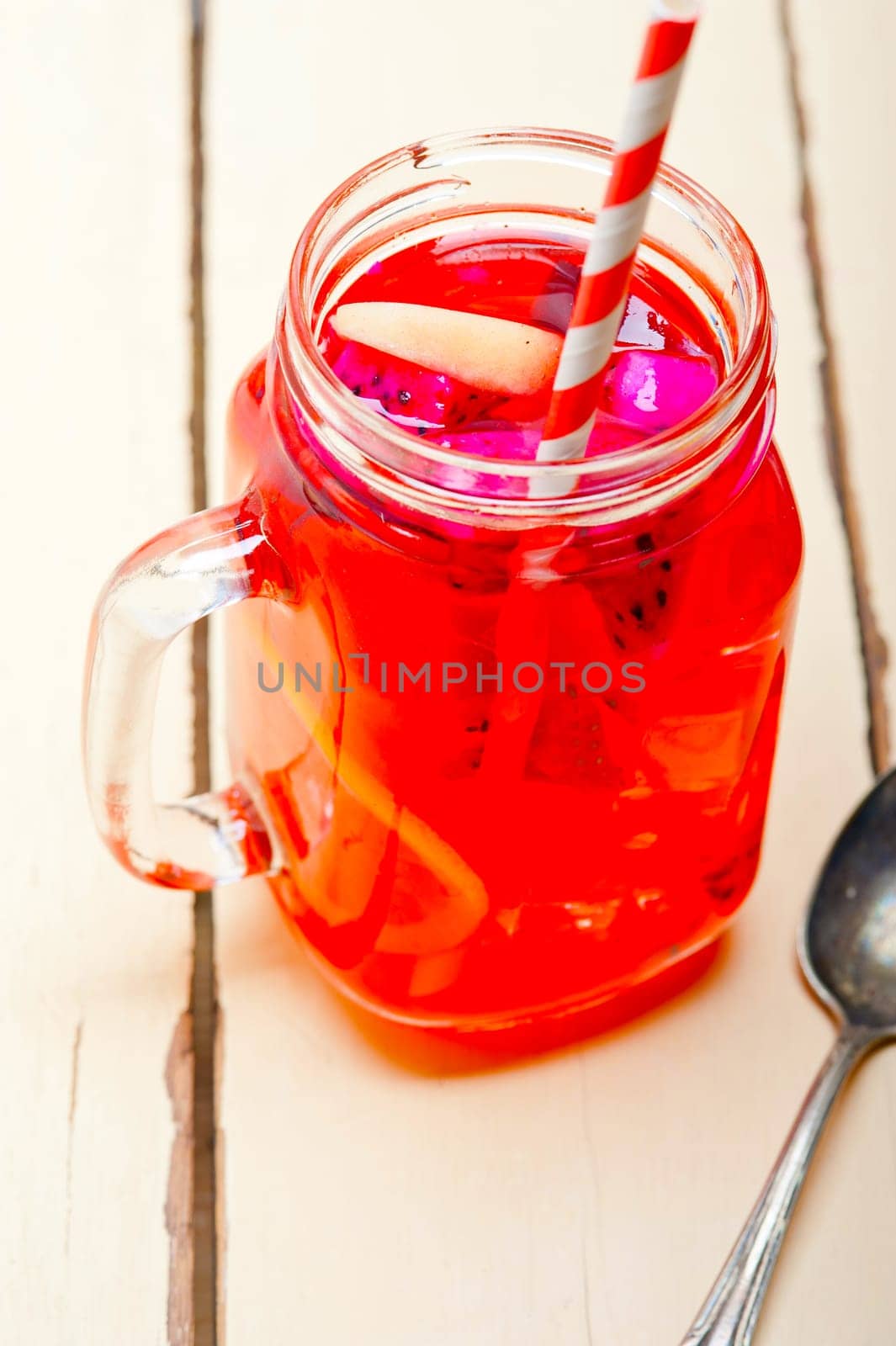 fresh fruit punch refreshing summer  drink over white rustic wood table