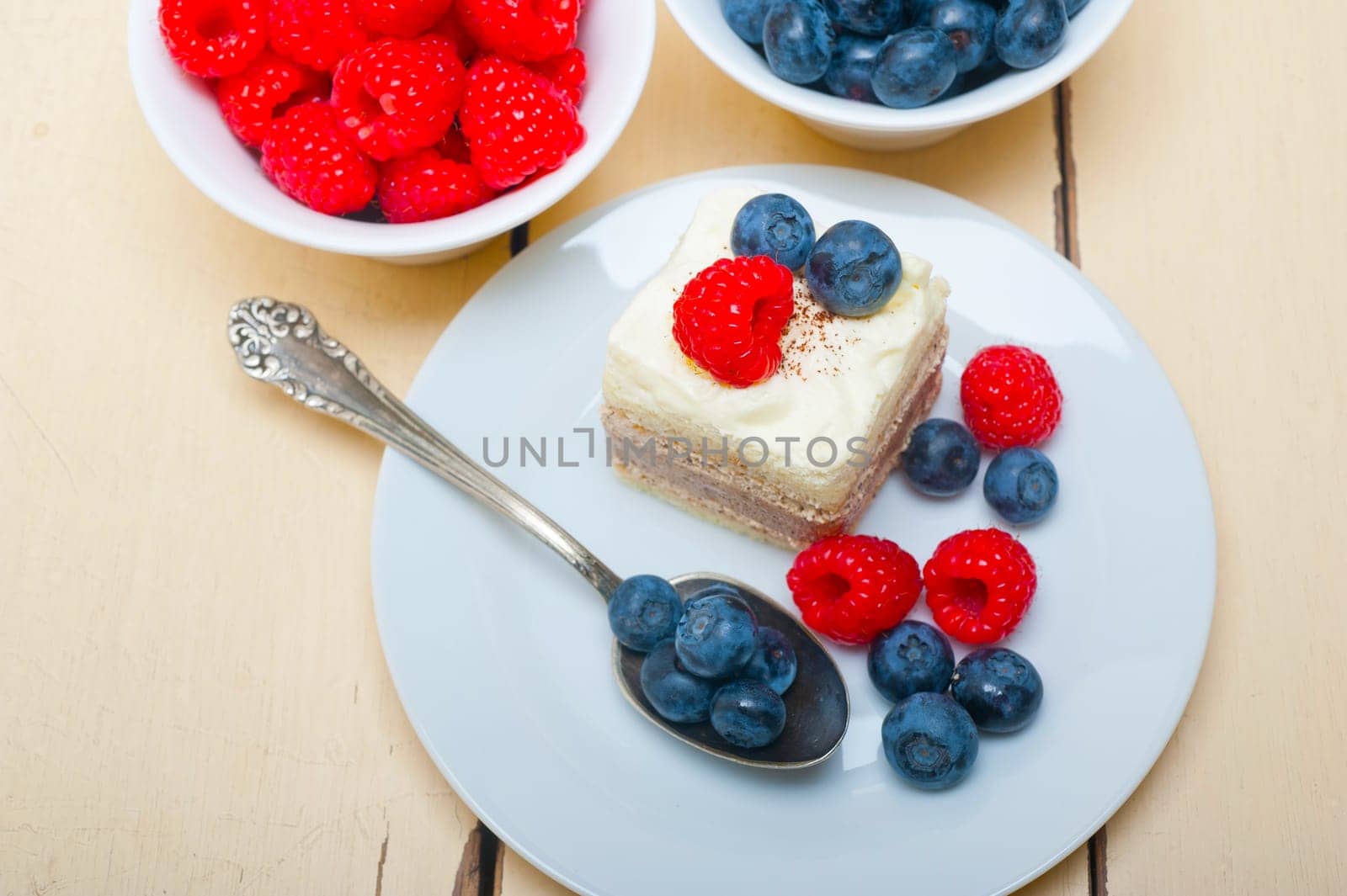 fresh homemade raspberry and blueberry cream cake 