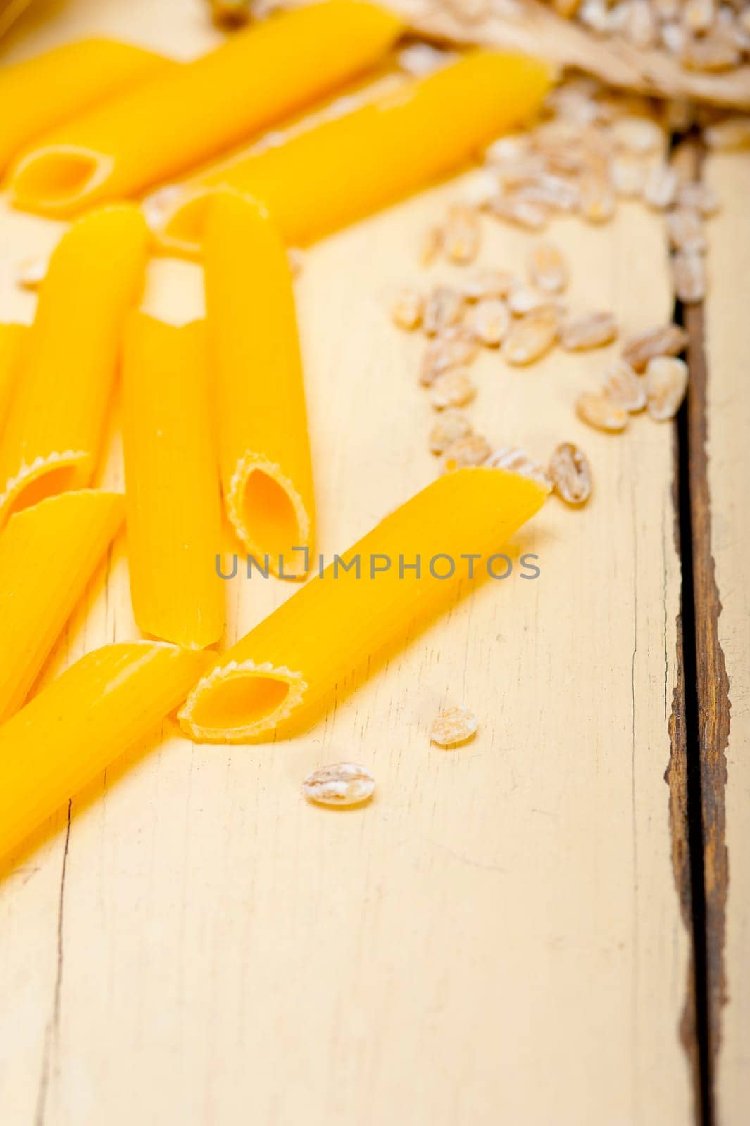 short Italian pasta penne with durum wheat grains