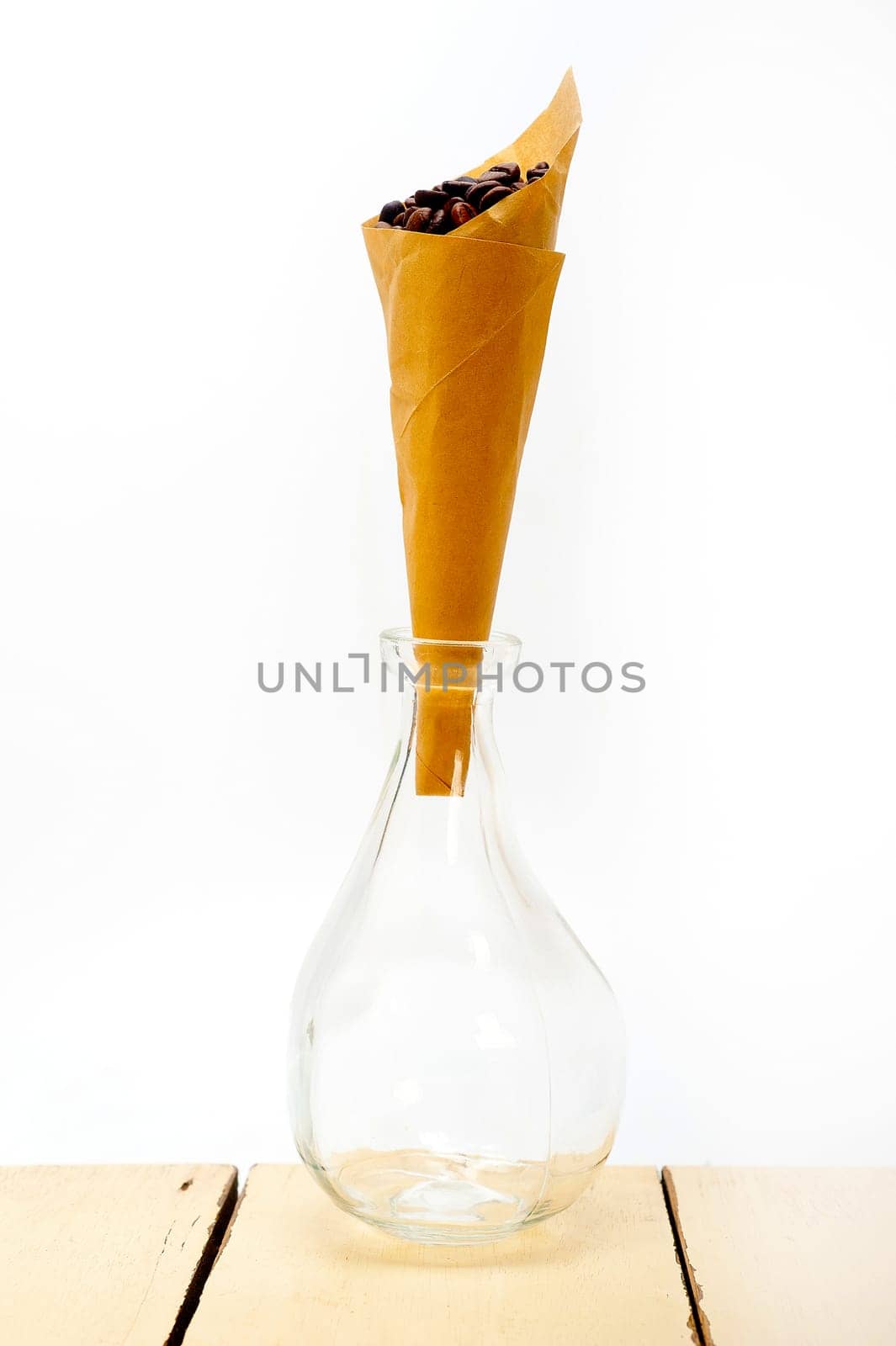 espresso coffee beans on a paper cone cornucopia over white background