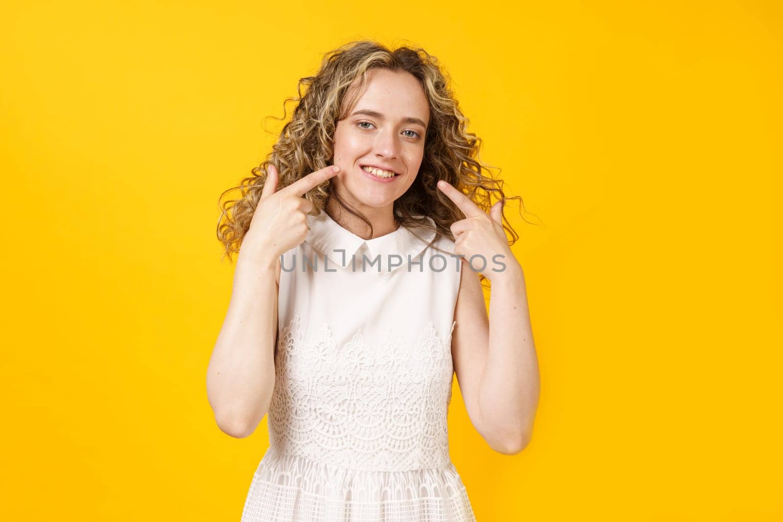 Portrait of a young smiling woman showing her smile with her fingers. Female portrait. by Sd28DimoN_1976
