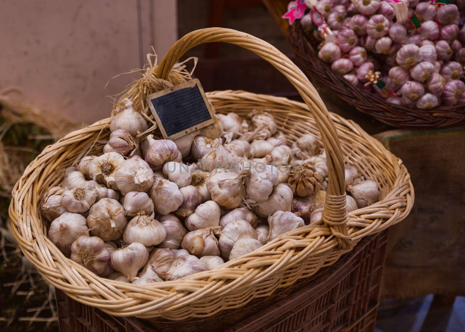 a big basket of garlic on the market in france