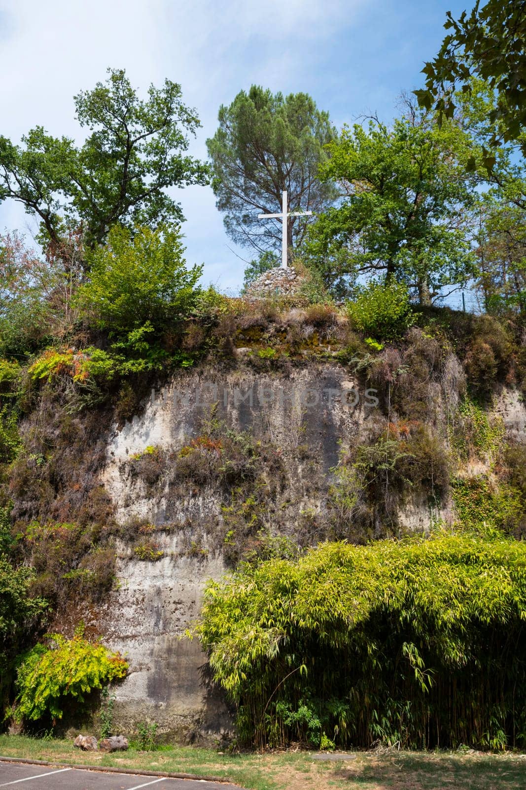 a n empty cross on the top of the chappel mountain of fransiscus from assisi in brive in france