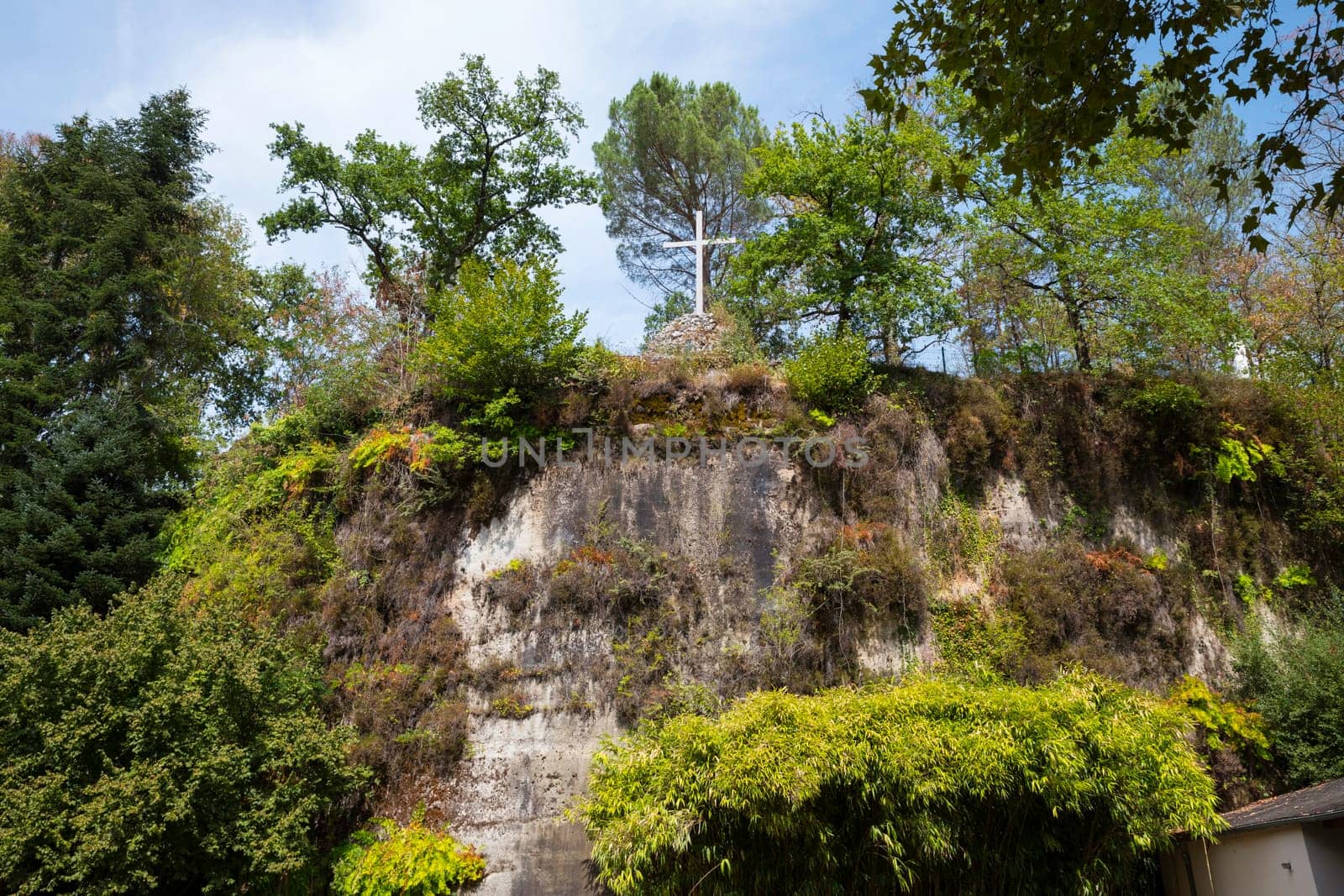 a n empty cross on the top of the chappel mountain of fransiscus from assisi in brive in france by compuinfoto