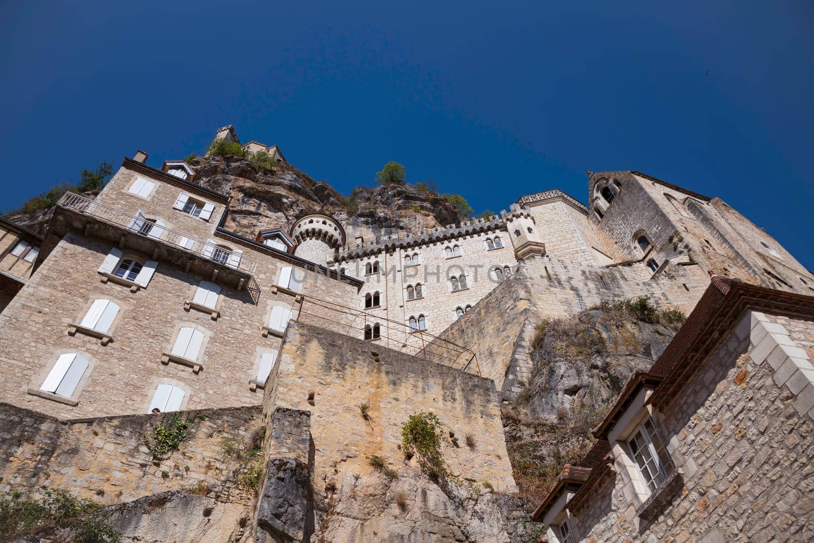 Pilgrimage town of Rocamadour, Episcopal city and sanctuary of the Blessed Virgin Mary, Lot, Midi-Pyrenees, France on a sunny hot day with blue sky