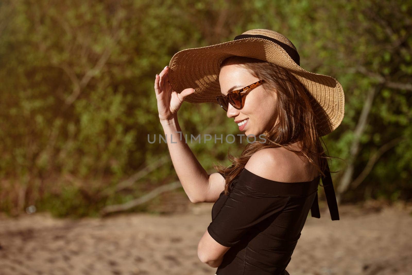 Young woman in straw hat close-up in sunglasses by EkaterinaPereslavtseva