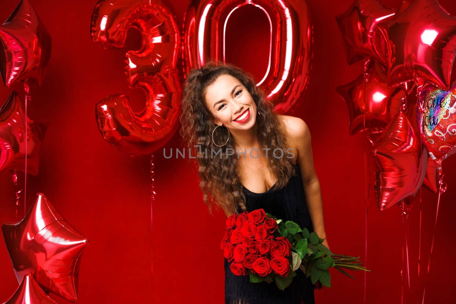 Beautiful young woman on a red background with red balloons by EkaterinaPereslavtseva