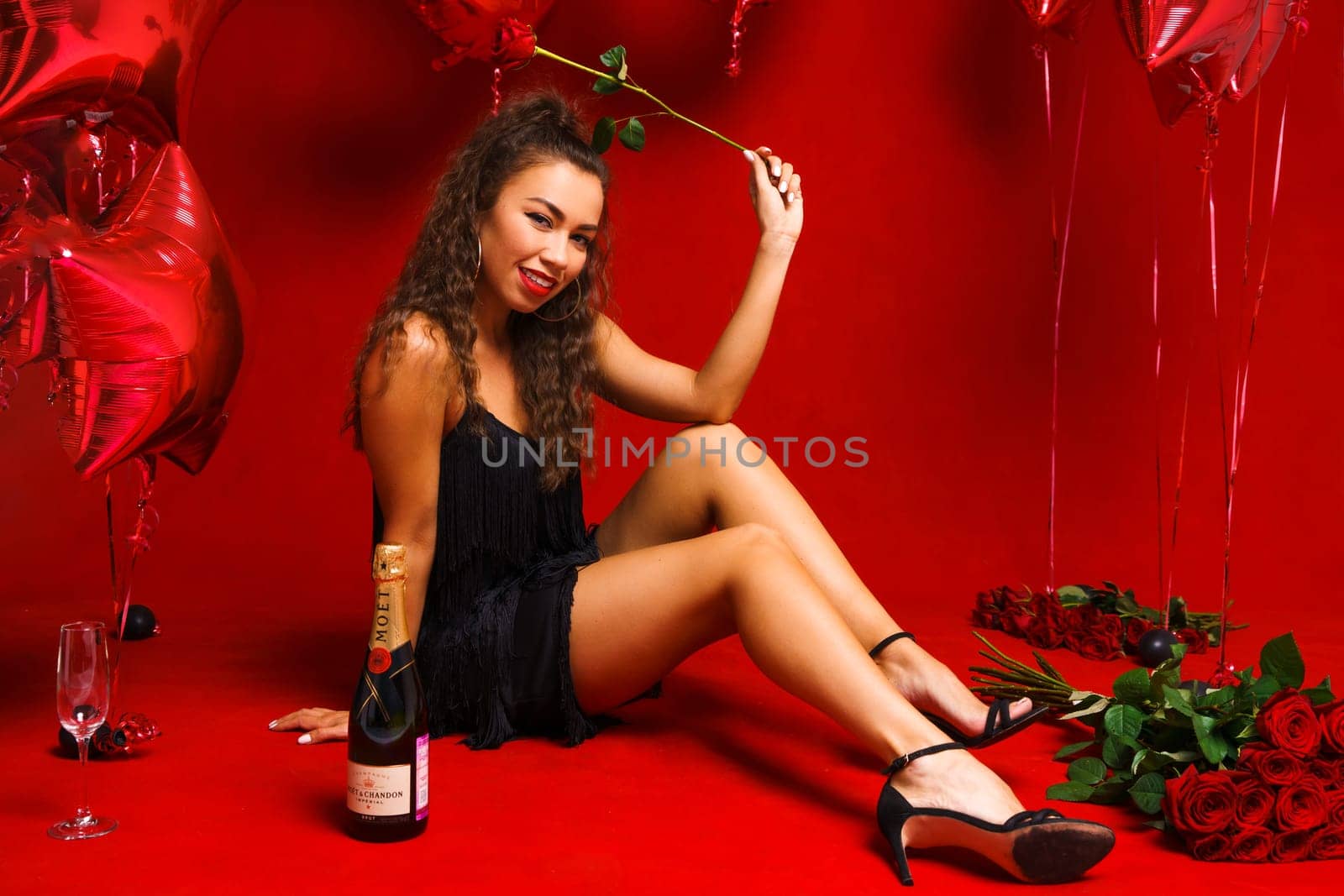 Girl posing sitting on a red background with roses by EkaterinaPereslavtseva