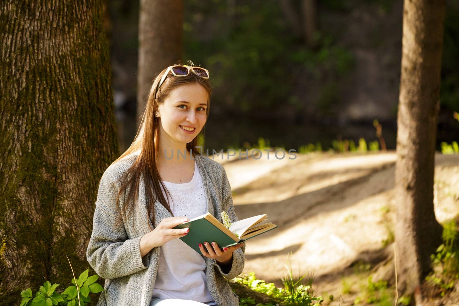 Cute girl in the park with a book in hand by EkaterinaPereslavtseva