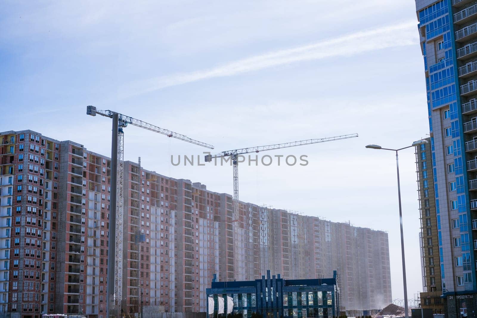 high-rise buildings under construction with by EkaterinaPereslavtseva