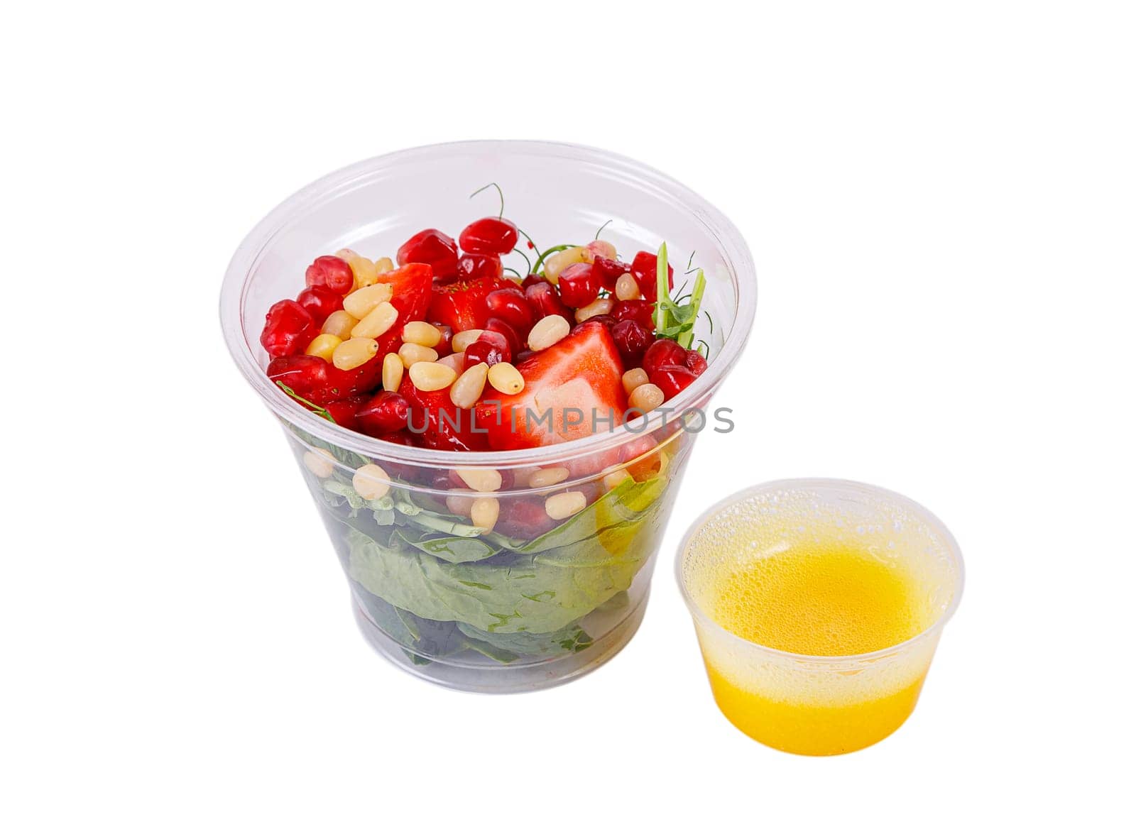 Salad with microgreens, strawberries, pine nuts and pomegranate seeds. Isolated, on a white background. Side view