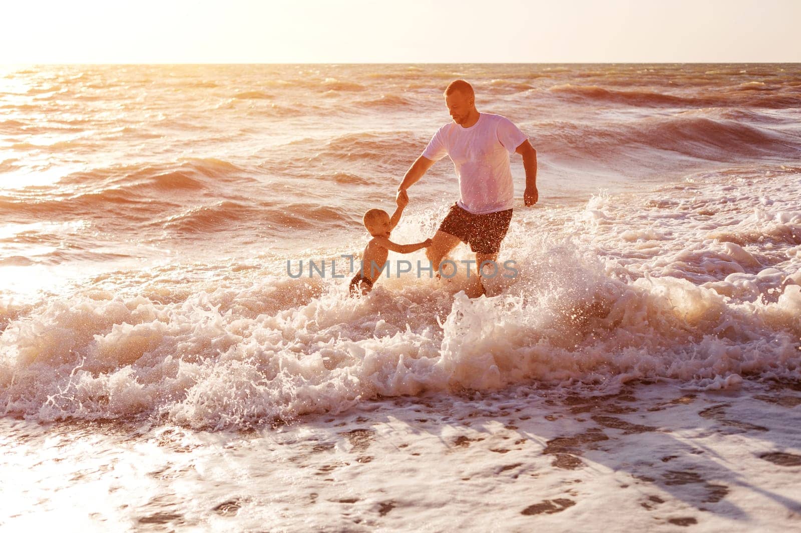 Happy dad and son swim in the sea. Holidays family by EkaterinaPereslavtseva