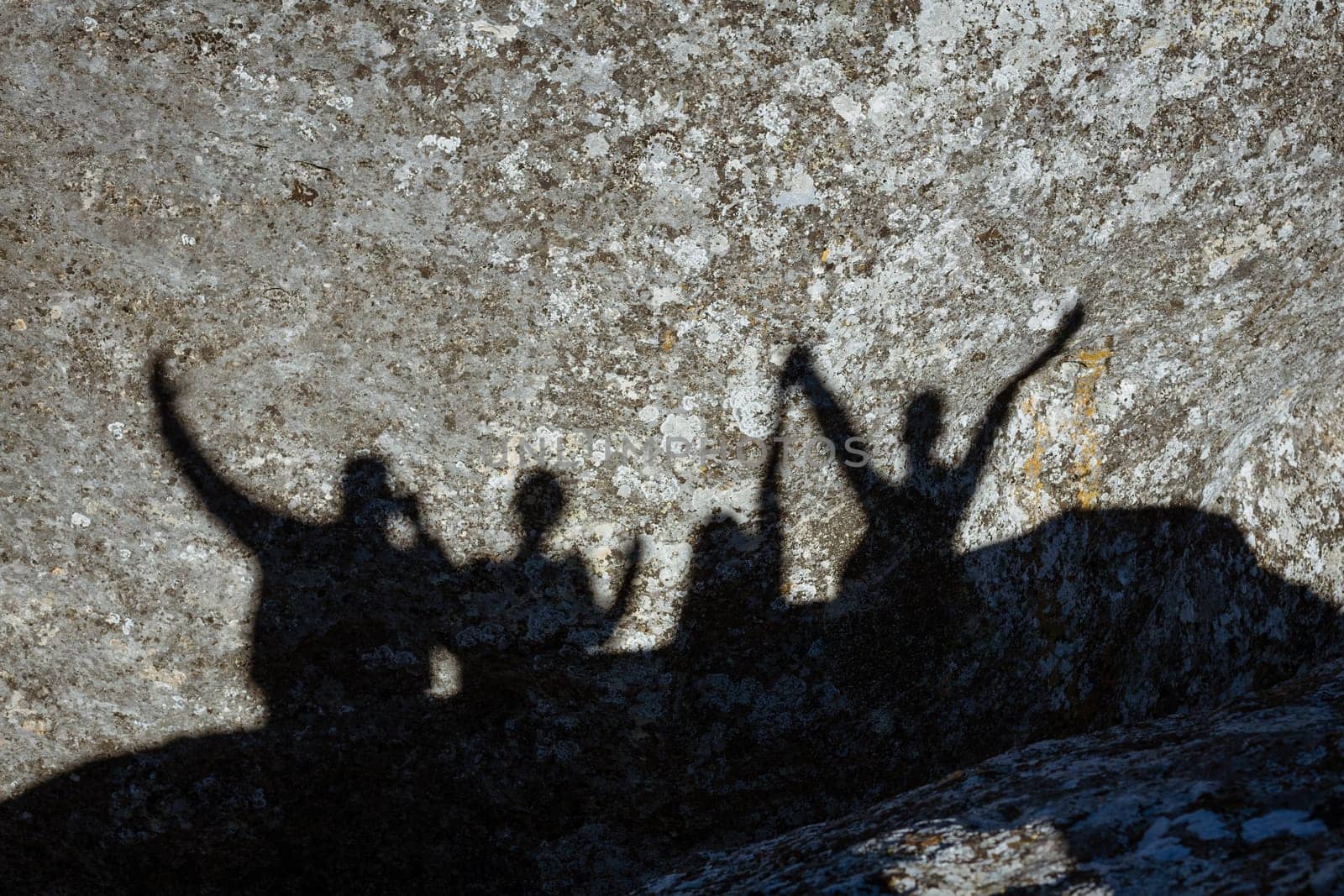 Shadow of a group of people on a rock by EkaterinaPereslavtseva