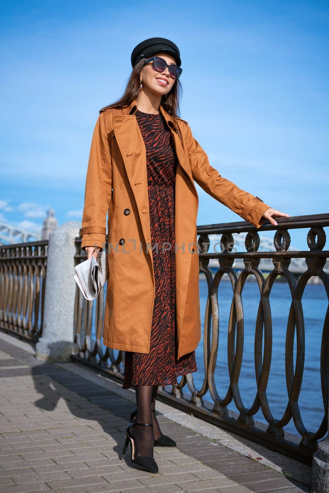 Young woman on the embankment with a newspaper in hand by EkaterinaPereslavtseva