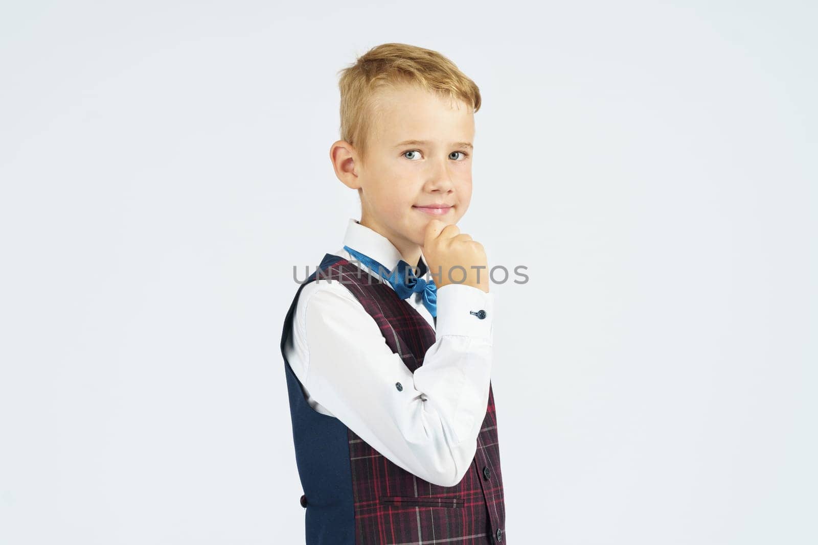 Portrait of a schoolboy looking at the camera. Isolated background. Education concept.