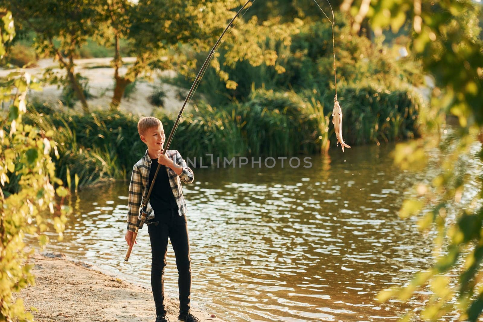 Boy in casual clothes in on fishion outdoors at summertime.